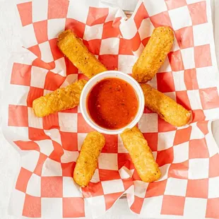 a plate of food with dipping sauce