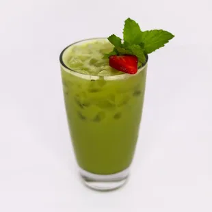 a green drink with a strawberry on top