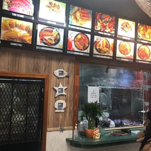 a woman standing in front of a menu