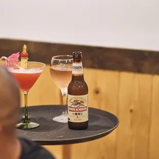 a man holding a tray with drinks