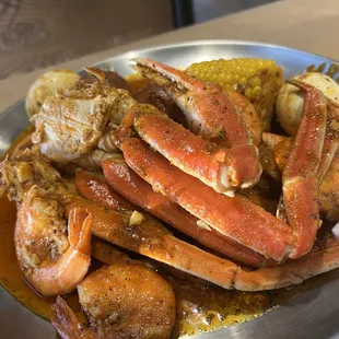 a plate of crab legs and corn