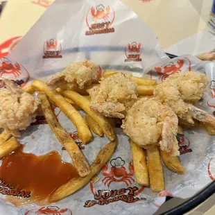 Shrimp and Cajun fries with hot sauce