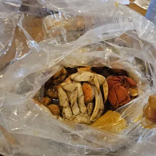 Dungeness crab, lobster tail, head off shrimp, potatoes, and corn in the medium heat Juicy Special seasoning.