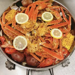 crab legs, corn and potatoes