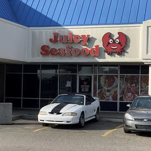 two cars parked in front of juicy seafood