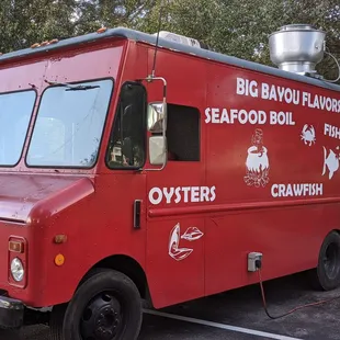 red food truck parked in a parking lot