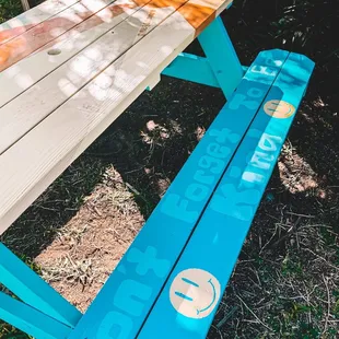 a picnic table with a painted bench