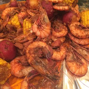 Shrimp boil with potatoes and corn. Tossed in woo pig sooie seasoning