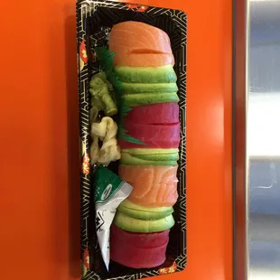 Raibow roll with tuna, salmon, avocado, and cucumber and crab meat inside