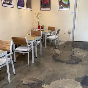 a dining area with tables and chairs