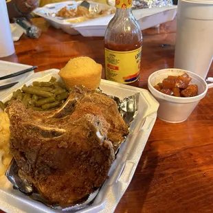 Fried pork chops Mac and cheese green beans yams and a corn muffin.