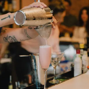 a bartender pouring a drink