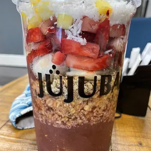 a plastic cup of fruit and yogurt