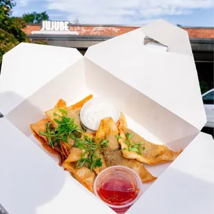 a person holding a box of food