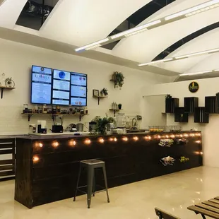 a kitchen with a bar and a television