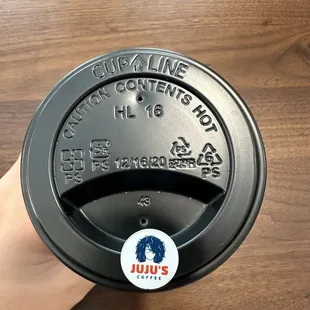 Stopper on to-go beverage with their cute logo