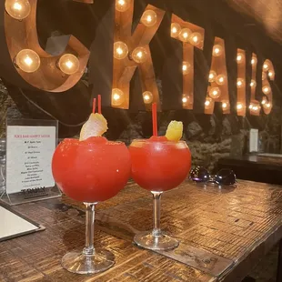 two cocktails on a wooden table