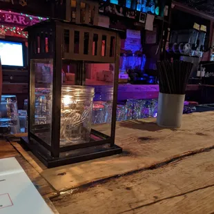 a lit candle on a wooden table