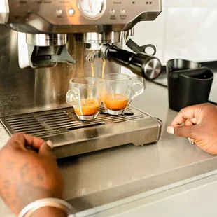 a person pouring coffee into a cup