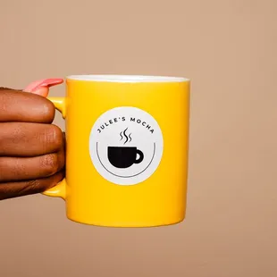 a person holding a coffee mug