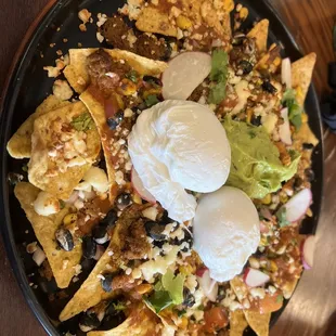  plate of nachos with sour cream