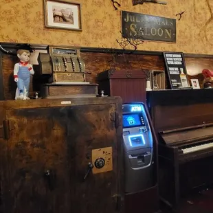 a piano and a deer head mounted on the wall