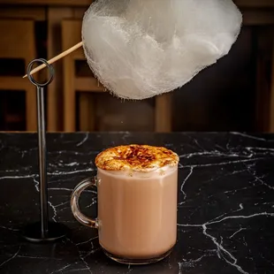 Crème brûlée, hot chocolate with cotton candy cloud at baklava bakery