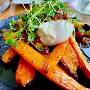 Burrata atop grilled carrots garnished with golden raisins and drizzled with balsamic.