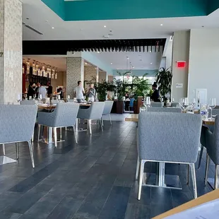 Cozy yet open air dining area looking into an adjacent bar.