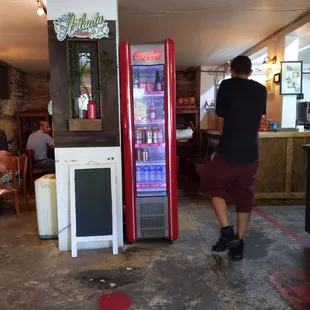 a man walking past a vending machine