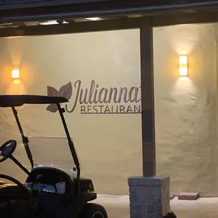 a golf cart parked in front of the restaurant