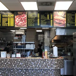 Large menu of mostly pizza, sandwiches, salads