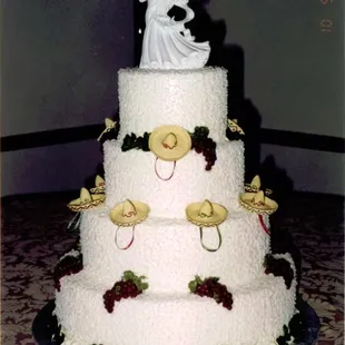a wedding cake with a bride and groom on top