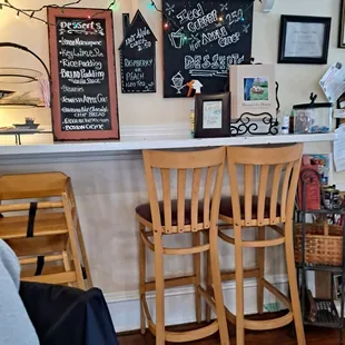 a bar with two wooden chairs