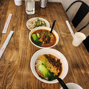 three bowls of soup on a table