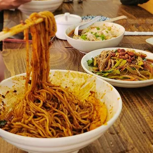 a bowl of noodles with chopsticks