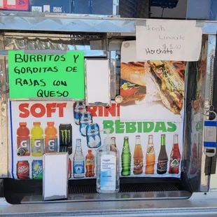 a display of burritos and sodas