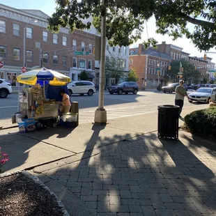 a hot dog cart on a city street