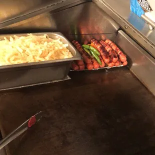 hotdogs being prepared in a commercial kitchen