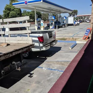 A truck parked in the blue line cross-hatched space where the ramp is.