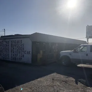 a truck parked in front of a restaurant