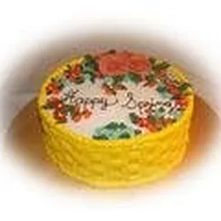 a yellow cake decorated with flowers