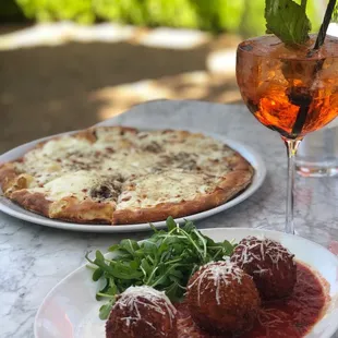 Arancini, Cacio e Pepe pizza and an aperol spritz