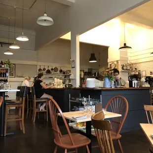 the interior of a restaurant with tables and chairs