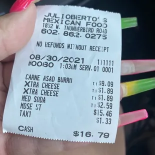 a hand holding a receipt