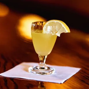 a glass of lemonade on a napkin