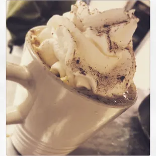 Cappuccino with homemade whipped cream and a splash of liquor