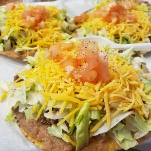 a taco topped with lettuce and tomatoes