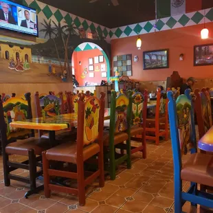 a mexican restaurant with colorful tables and chairs