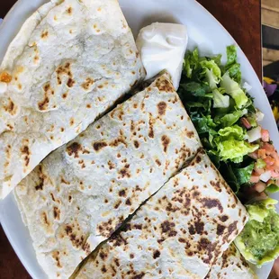 a plate of quesadillas and a salad